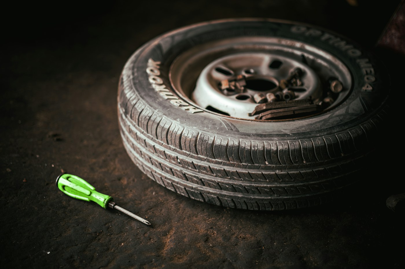 Tyre, wheel and tools on a workshop floor